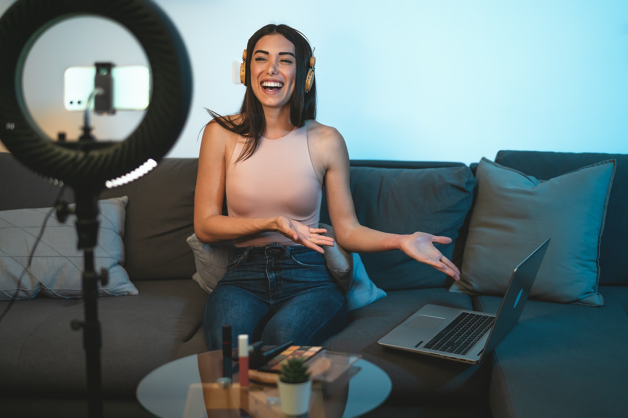 female-influencer-vlogging-online-with-smartphone-cam-and-laptop-from-home.jpg